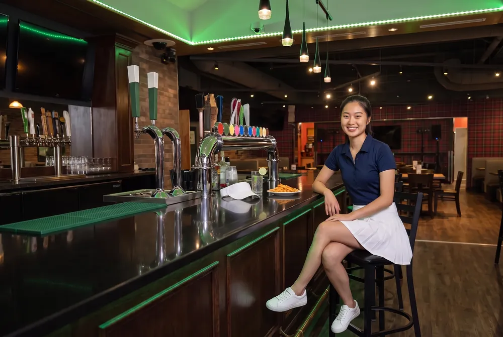 A woman at the Celtic Junction bar after a round